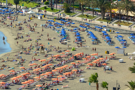 Blue parasols and sunbeds are on urban coastline. Famous urban beachesのeditorial素材