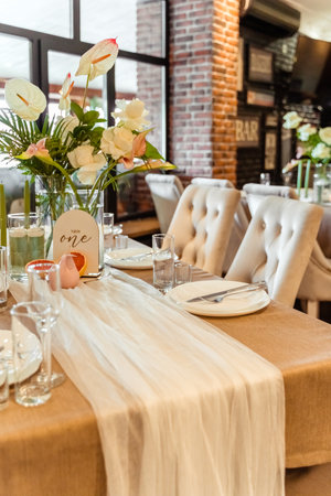 orchids and beige chairs in a cozy cafeのeditorial素材