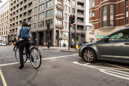 Old woman with her bike in the traffic of Londonのeditorial素材