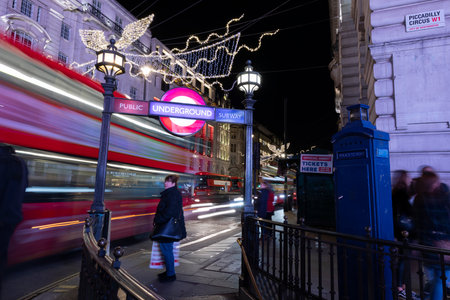 Woman with a Red Bus Moving, Piccadilly Circus, Londonのeditorial素材