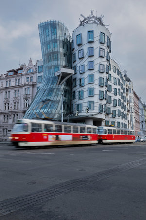 Red Tram Moving in front of the Dancing House, Pragueのeditorial素材