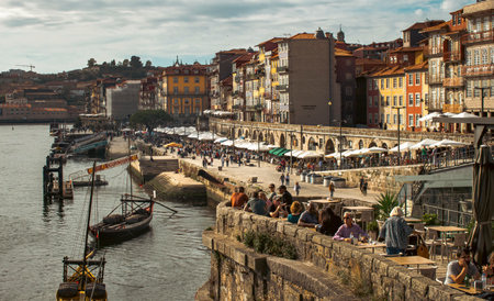 Promenade in Porto, people walk, relax and swim in boatsのeditorial素材