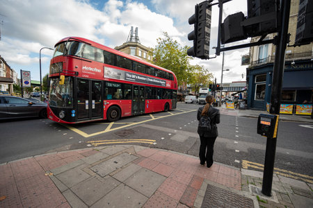 London bus crossing the streets of Kilburnのeditorial素材