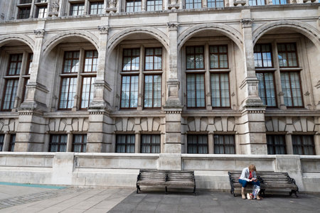 Woman seated on a bench at Victoria and Albert Museumのeditorial素材