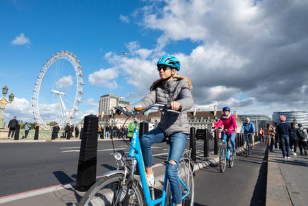 Young blond girl and family cycling on Westminster Bridgeのeditorial素材