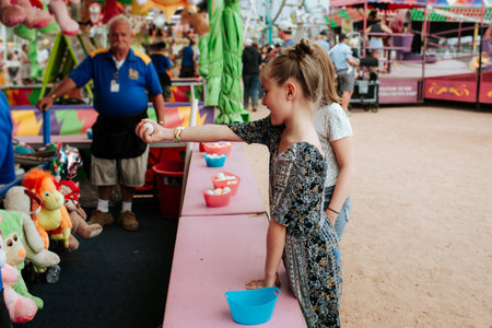 Young girl playing a game at a carnivalのeditorial素材