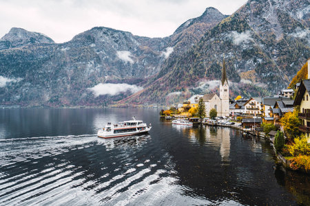 view of the village of hallstatt from the church and a boat arrivingのeditorial素材