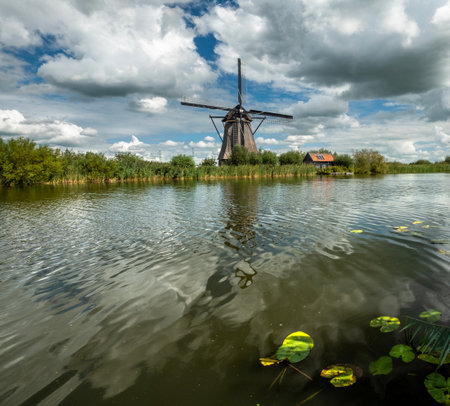 Postcard of a windmill and the canals under a gray sky in Kinderdijkのeditorial素材