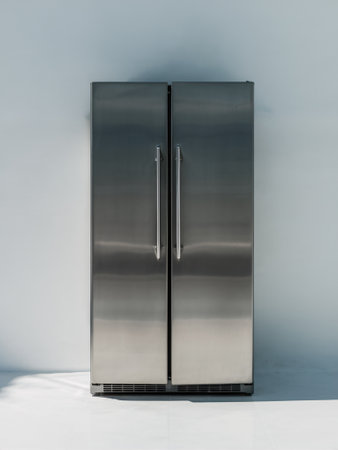Modern stainless steel refrigerator against a minimalist backdrop, showcasing sleek design and functionality.の素材