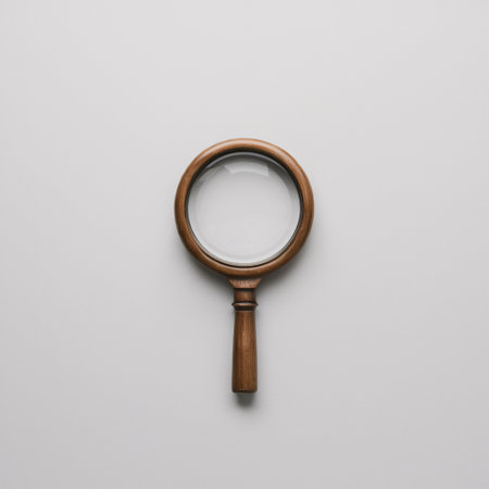 A classic wooden magnifying glass on a minimalistic white background.の素材