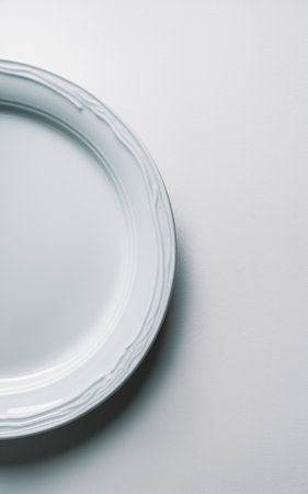 Elegant white plate with intricate rim design, perfect for gourmet dining, minimalistic aesthetic.の素材