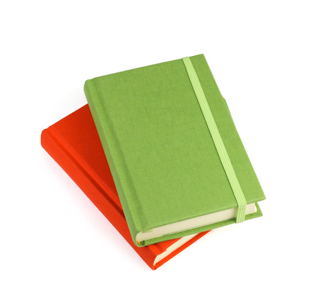 Green and red notebooks isolated on white の写真素材