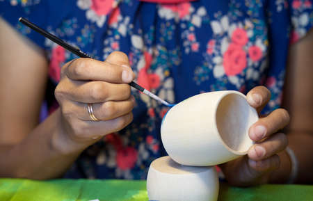 The artist paints with bright colors