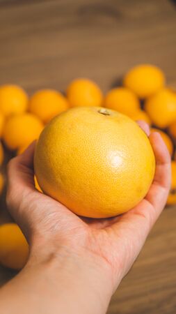 Picture of Big grapefruit with medlars at backgroundの写真素材