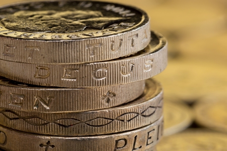 Close up of British money, pound coins stacked up.