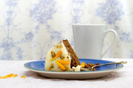 Slice of carrot and marigold cake ready to eat for an afternoon snack. With Toile de jouy...