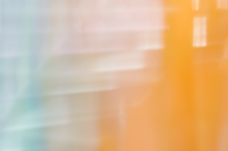 Blurred abstract background. Painterly smears of white and blue on orange.の写真素材