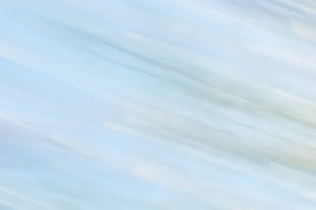 Blurred abstract background. Minimalistic pale pastel blue and white stripes.の写真素材