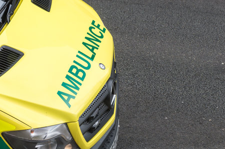 WREXHAM, UK - AUGUST 30, 2016: Bonnet of an emergency service ambulance on a street in Wales. Elevated point of view, with copy space.のeditorial素材