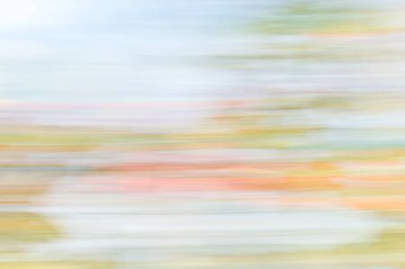 Blurred abstract background.  Orange blue and green stripes.