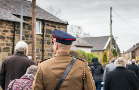 WREXHAM, UK - NOVEMBER 13, 2016: The Remembrance Parade along Park Road, Coedpoeth. An annual parade from St Tydfil church to the War memorial on Remembrance Sunday, also known as Poppy Day.のeditorial素材