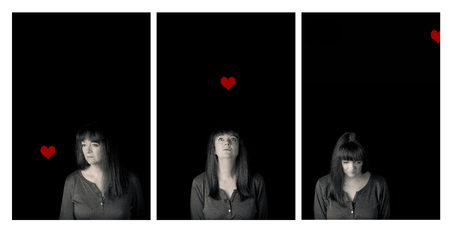 Triptych portrait of a mature woman and a red heart. Conceptual story of love and loss. Low key.の写真素材