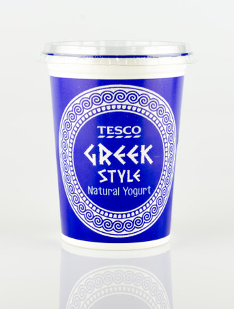 WREXHAM, UK - MAY 24, 2017: A pot of Tesco own brand Greek style natural yogurt. On a white background.のeditorial素材