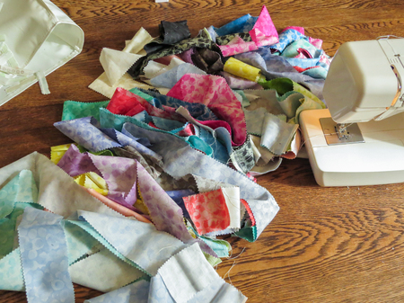 Jelly roll fabric sewn together in a long line, used to make a jelly roll quilt. Part way though...