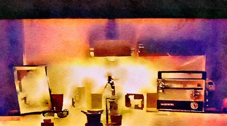Watercolor abstract painting of a cluttered retro desktop with old radio and picture frames lit from above in orange and purple colours.の写真素材