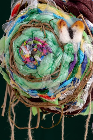 Recycled plastic waste woven sculpture and felted Orange-tip butterfly. Environmental impact of...