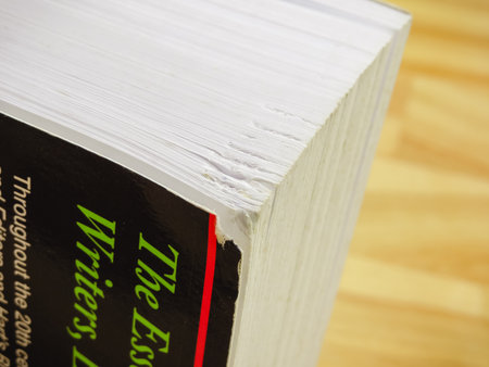 Wrexham, UK - January 17, 2018: Damage to corner of a thick writers paperback book. Close up detail.のeditorial素材