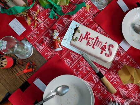 Leftover Christmas cake and empty plates on a messy table after the party. Overhead view.の写真素材