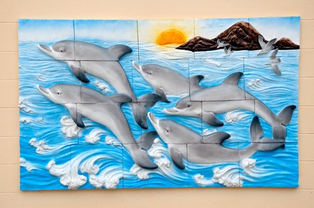 The Carving sandstone of dolphins on wall backgroundのeditorial素材