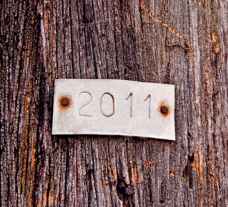 The Aluminum plate of 2011 on old wood backgroundの写真素材