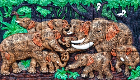 The Sculpture of family elephant on wallの写真素材