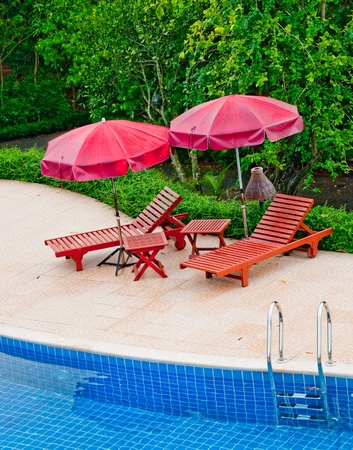 The Wooden bed with umbrella at poolのeditorial素材