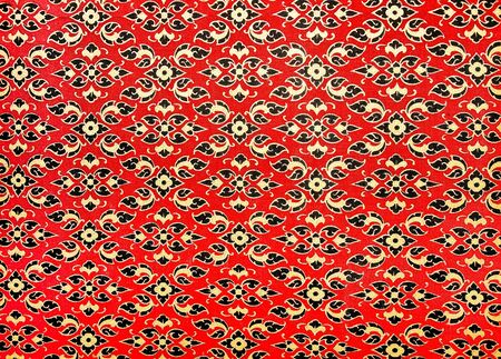 The Traditional Thai style art golden painting pattern on the wall in temple. This is traditional and generic style in Thailand.の写真素材