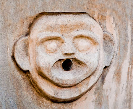 The Sculpture of head men on wallの写真素材