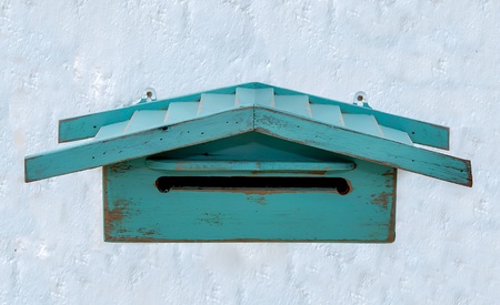 Old wooden mailbox on white wall backgroundの写真素材