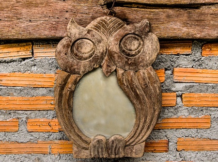 Carving wooden of  owl bird on brickwall backgroundの写真素材
