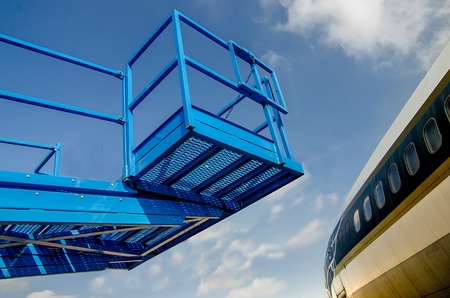 view of ramp with airplane on blue sky backgroundの写真素材
