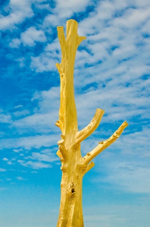 Golden dead tree isolated on blue sky backgroundの写真素材