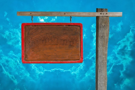 Wooden sign blank isolated on blue sky backgroundの写真素材