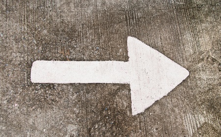 White arrow on the road floor backgroundの写真素材