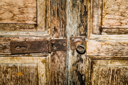 Closeup of old rusty door hinge on wooden doorの写真素材