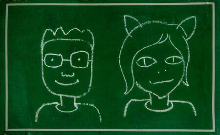 Sketch of boy and girl on blackboardの写真素材
