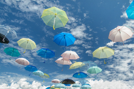 Multicolored umbrellas against blue sky backgroundの写真素材