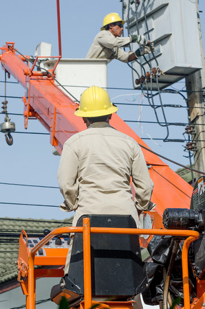 Minburi, Thailand- Nov 9:Electrician are installing high powered electric cables to cope with the increasing power usage of cities surrounding Bangkok. 
in minburi Thailand on Nov 9,2013のeditorial素材
