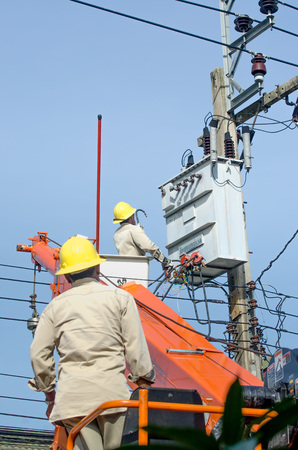 Minburi, Thailand- Nov 9:Electrician are installing high powered electric cables to cope with the increasing power usage of cities surrounding Bangkok. 
in minburi Thailand on Nov 9,2013のeditorial素材