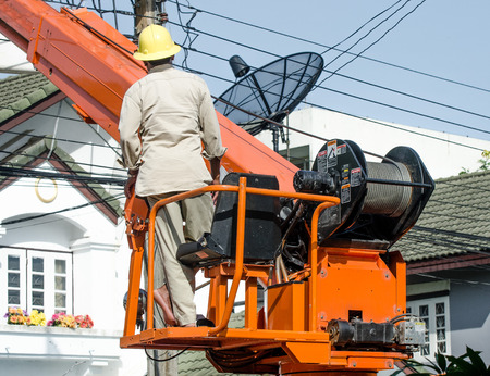 Minburi, Thailand- Nov 9:Electrician are installing high powered electric cables to cope with the increasing power usage of cities surrounding Bangkok. 
in minburi Thailand on Nov 9,2013の写真素材